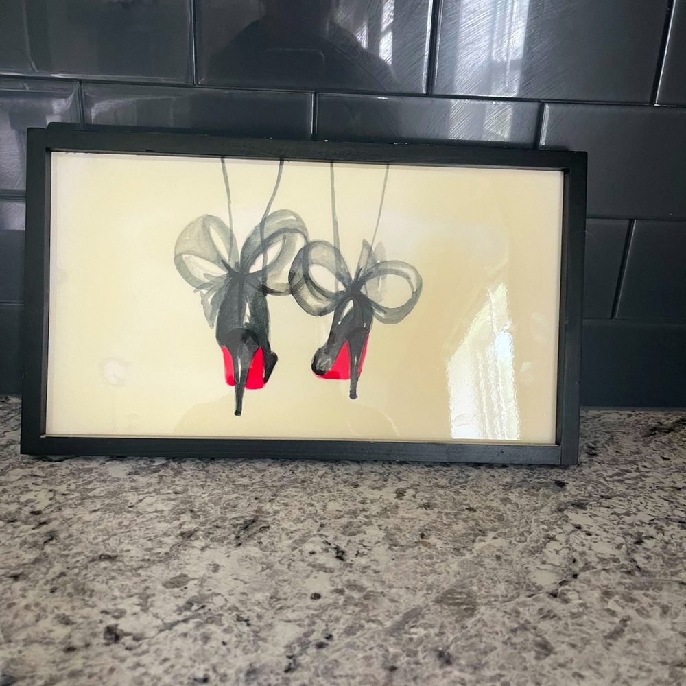 Wall decor of Christian Louboutin heels.